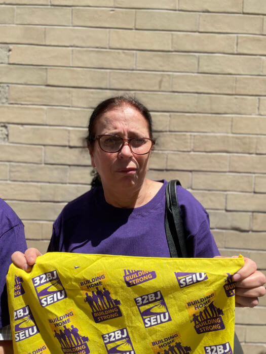 hasije demirovic with yellow union sign outside brooklyn law school