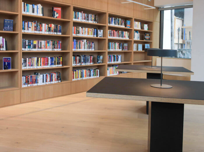 sunlit bookshelves and table at new brooklyn heights library