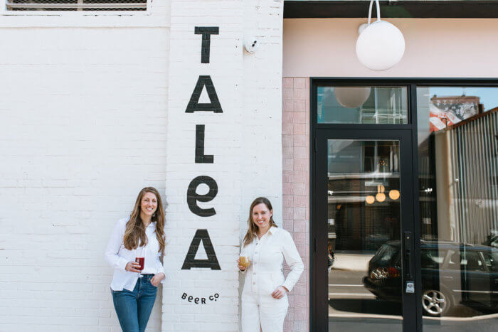 talea cofounders standing outside williamsburg talea sign