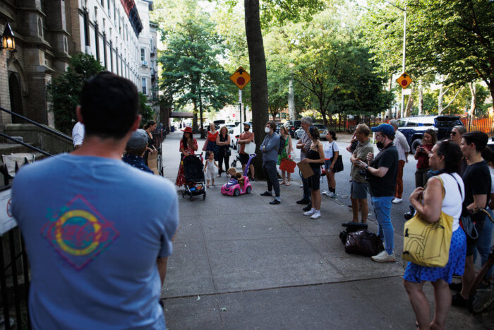 people gather outside park church coop