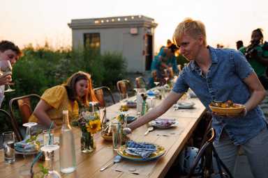 people sitting down at compost dinner at brooklyn grange