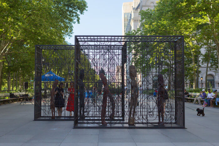 statues inside fencing in sculpture called "mind forged manacles/manacle forged minds"