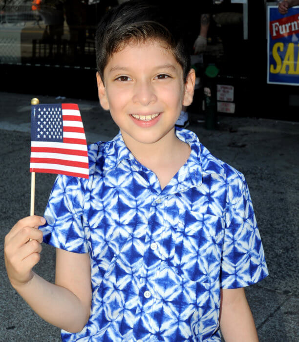 child with flag at independence day parade