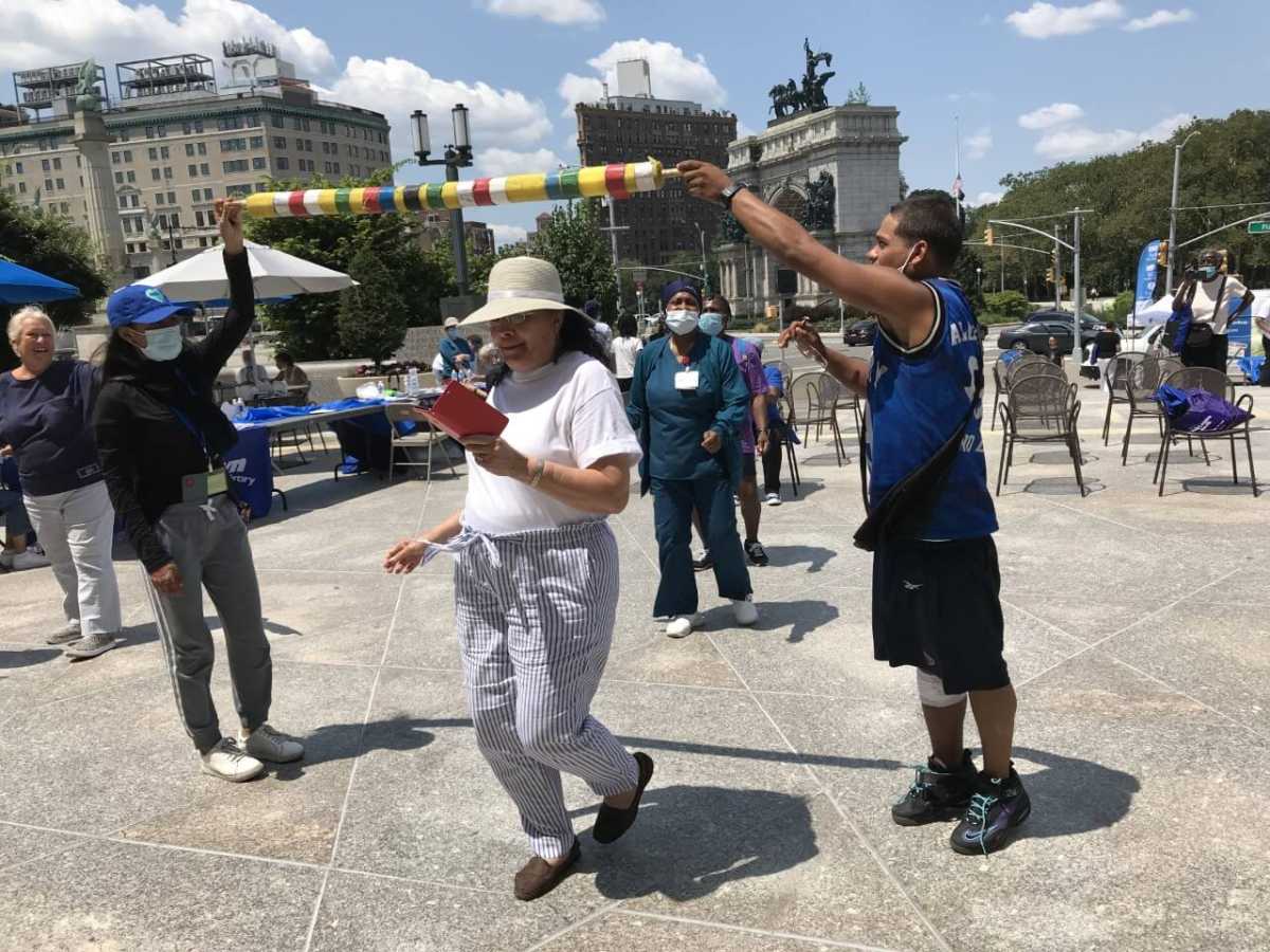 people look at canvases at brooklyn public library age my way senior resource fair