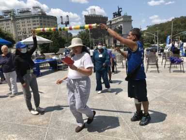 people look at canvases at brooklyn public library age my way senior resource fair