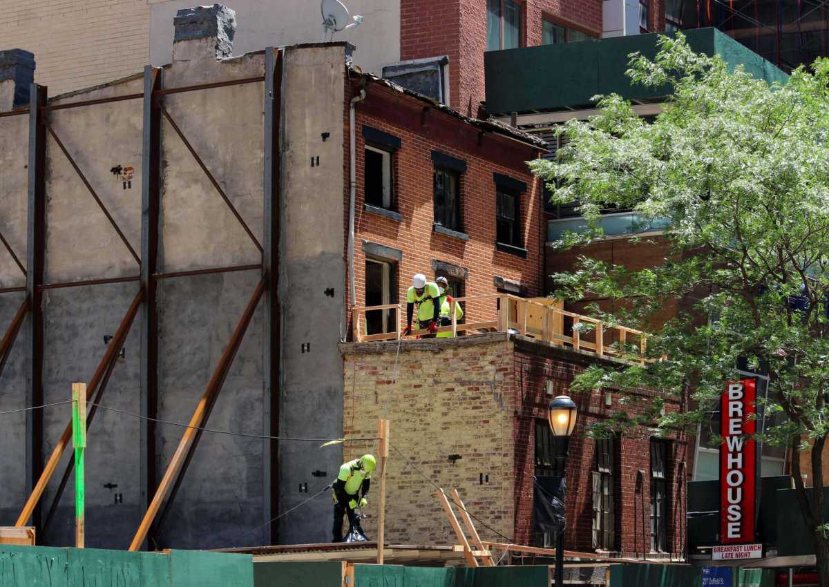 construction workers at first floor roof of abolitionist place