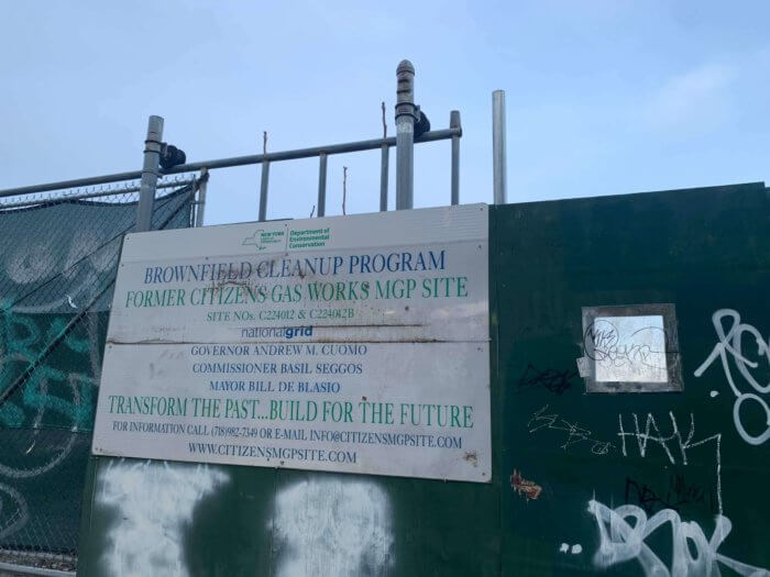 fence with signs outside public place gowanus rezoning