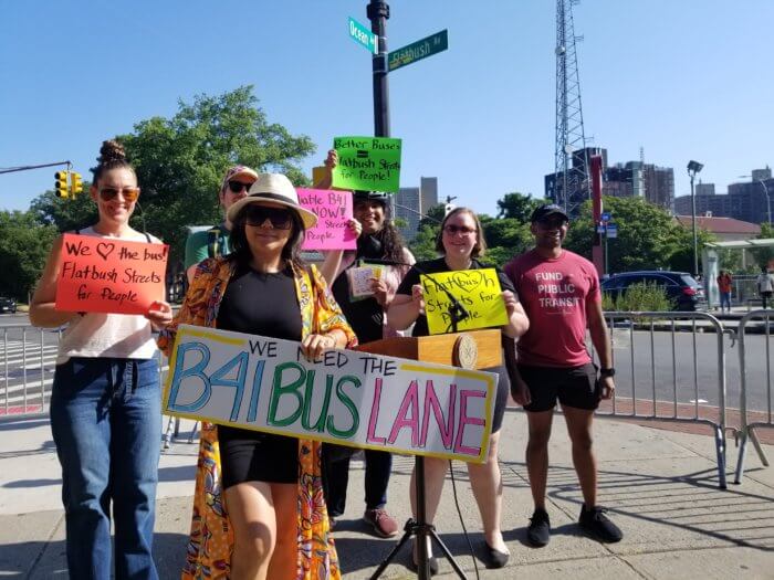 people with signs in support of flatbush avenue bus lane