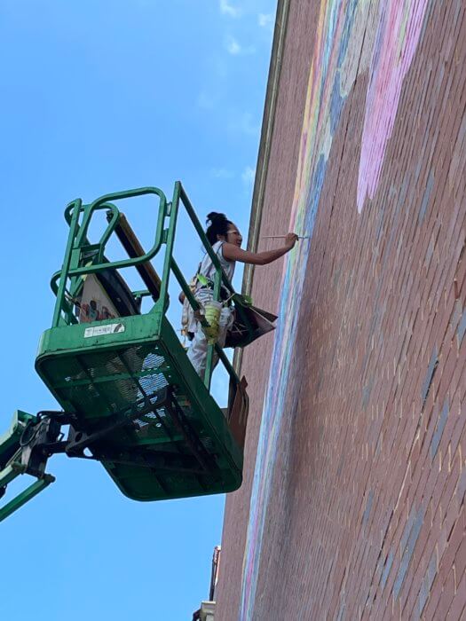 artist finishing mural at ps 295