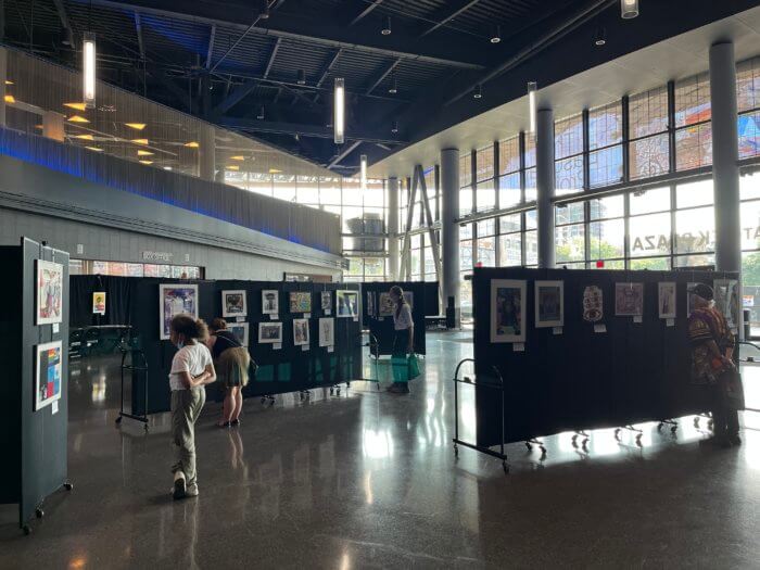 people browse artworks at barclays basquiat exhibit