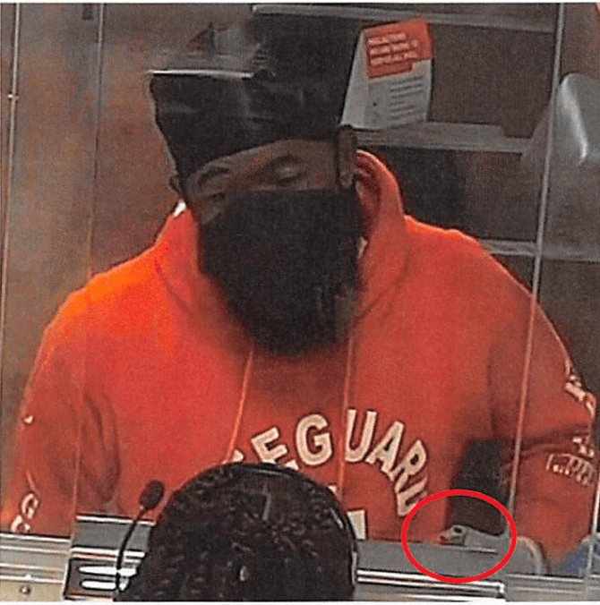 The alleged lifeguard bandit is seen in a red "Lifeguard" hoodie at the scene of the crime. Ricardo Subero, the defendant, suspectedly flashed a gun to the bank teller while demanding money.