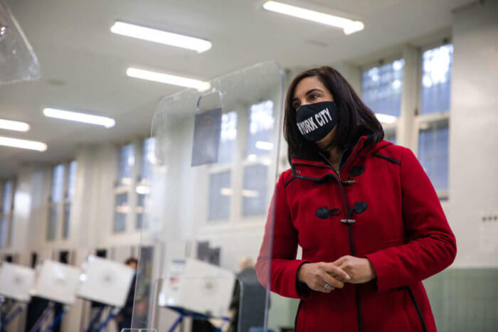 nicole malliotakis in red coat and black mask. malliotakis will face max rose in the general election