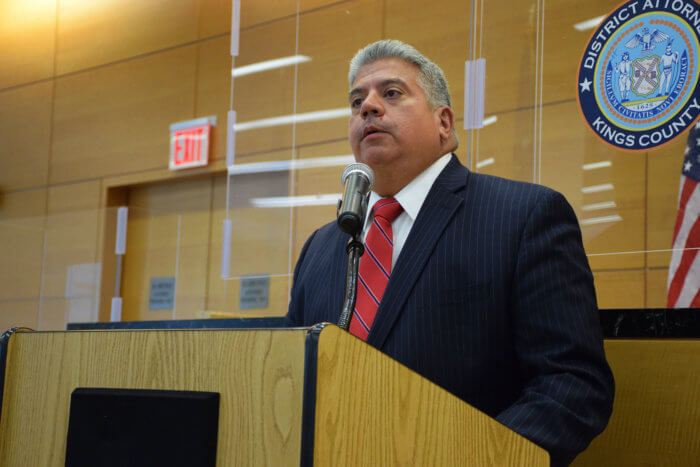 brooklyn DA eric gonzalez in suit at podium