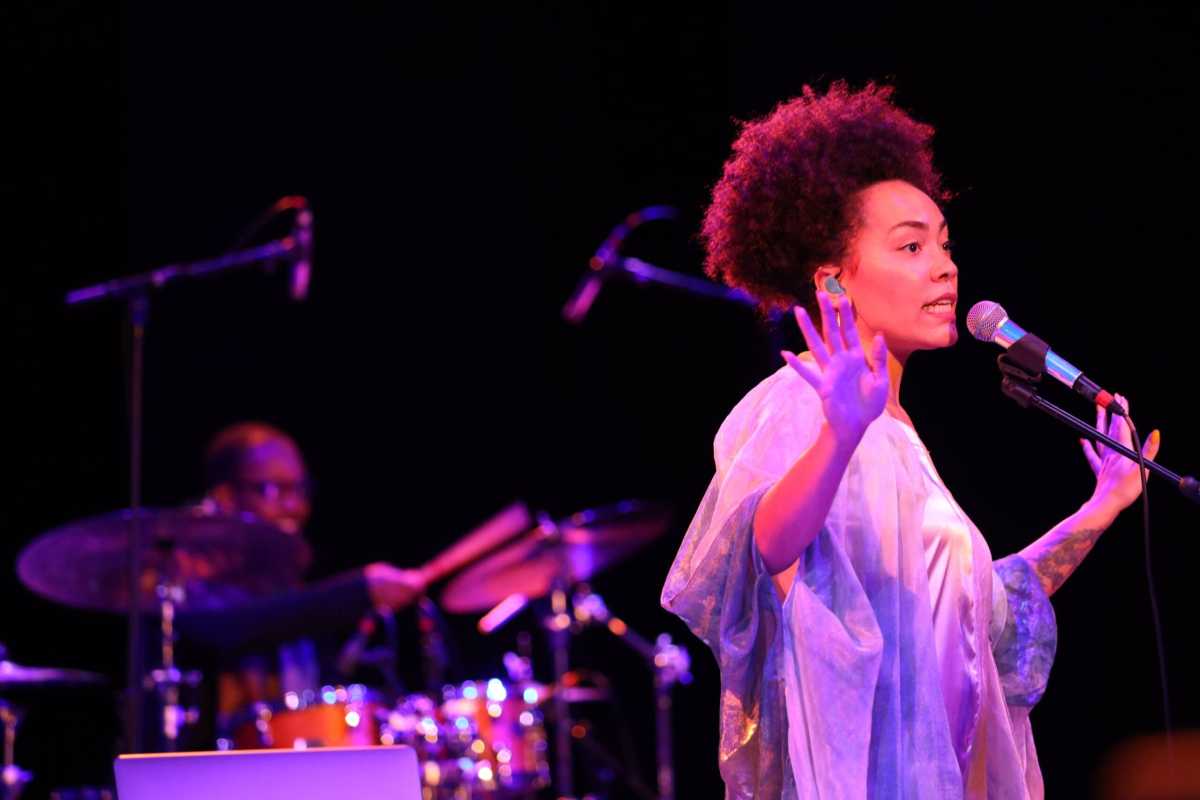 woman sings at microphone at JazzFest