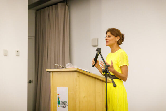 woman in yellow dress at podium