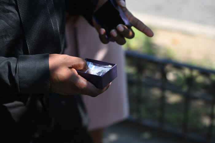 man holding locket at funeral