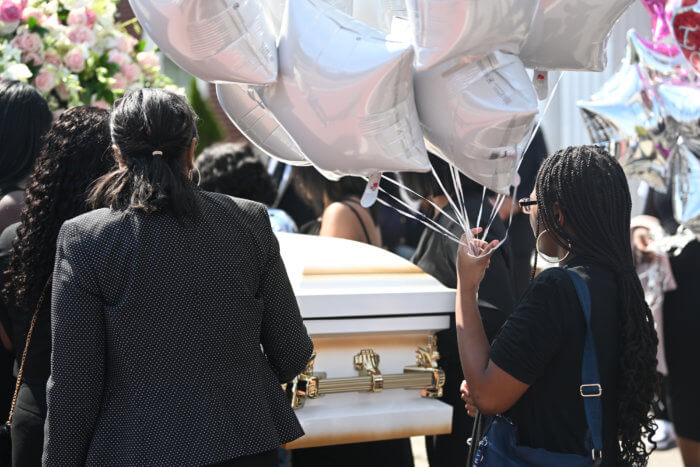 women with liliana merdy's casket