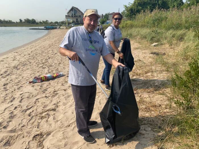people pose at beach cleanup