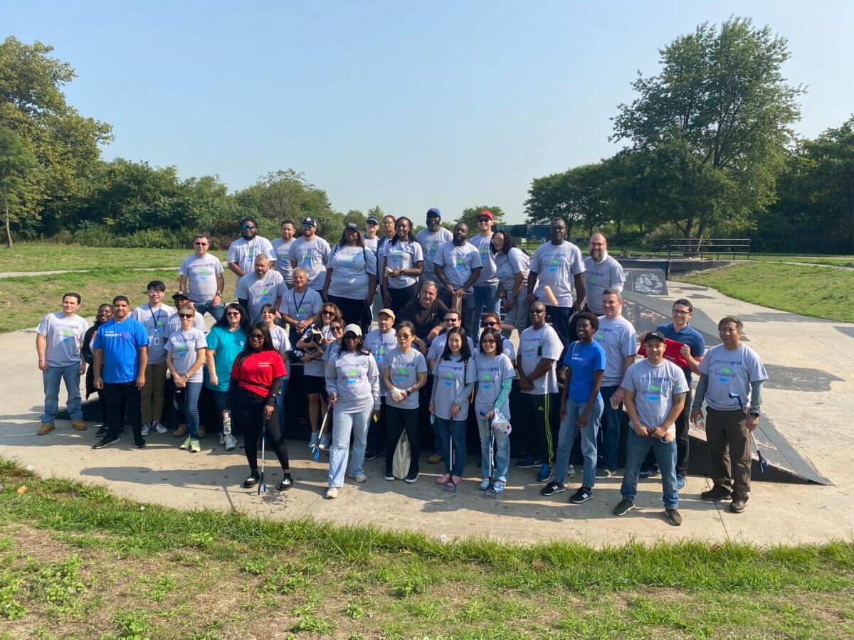 people pose on field at national grid day of service