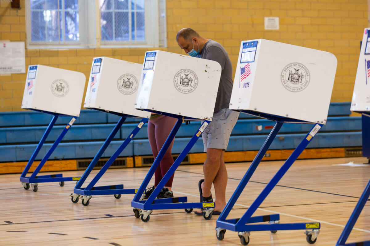 voters on election day in voting booths