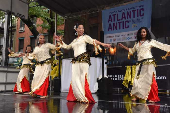 Dancers perform in the rain during the Atlantic Antic festival on Sunday, Oct. 2, 2022.
