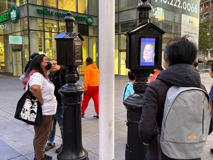 people look at police box art installation