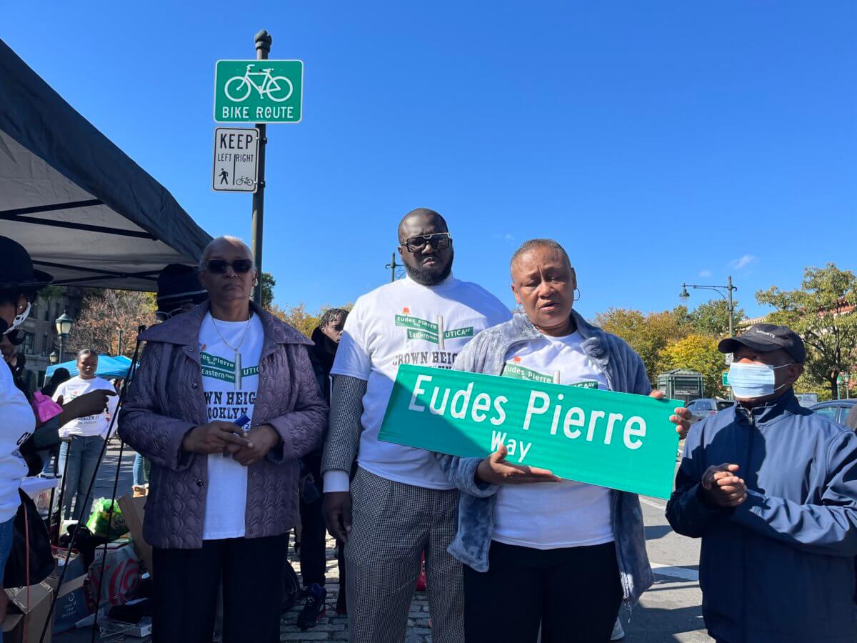 family of eudes pierre with street sign
