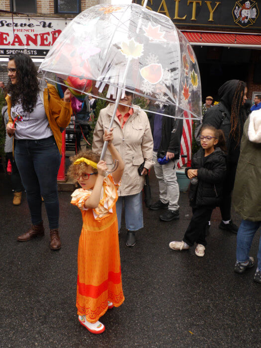 child dressed at ragamuffin parade with umbrella
