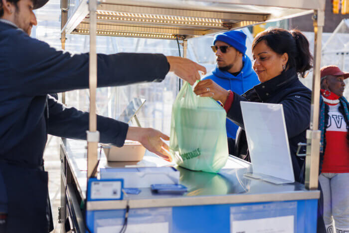 woman takes salad at the doe fund giveaway