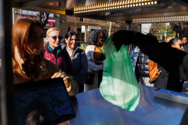 person with bag of salad at the doe fund