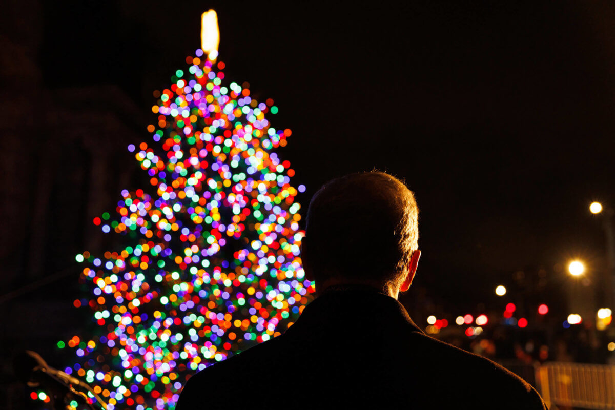 man watching holiday lighting