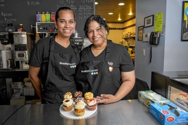 women standing in brooklyn cupcake with cupcakes