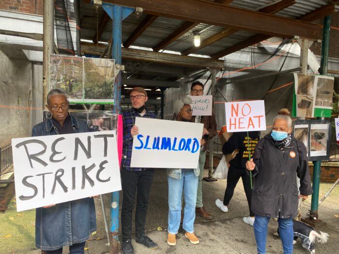 flatbush tenants hold signs that call for a rent strike