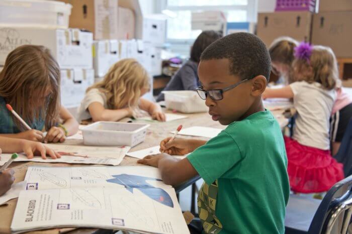 child at school desk