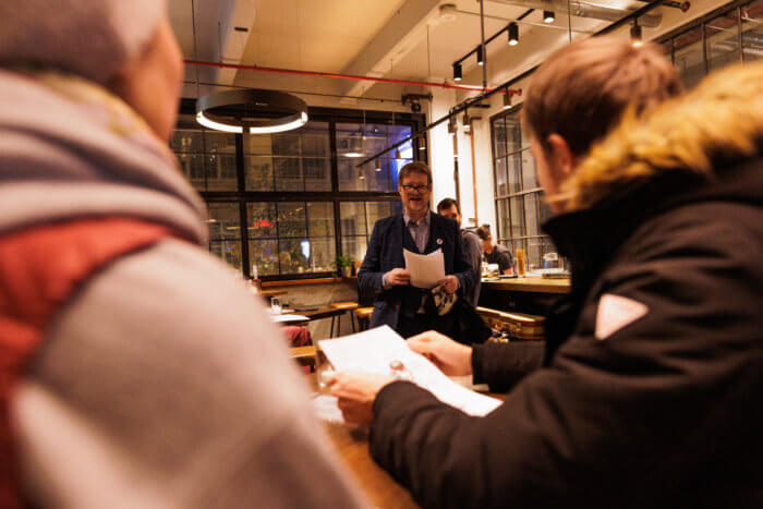 man reading from script in bar