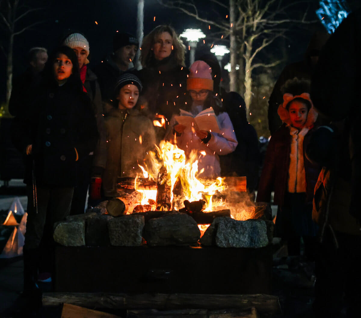 people gather around the fire at the secret lantern society