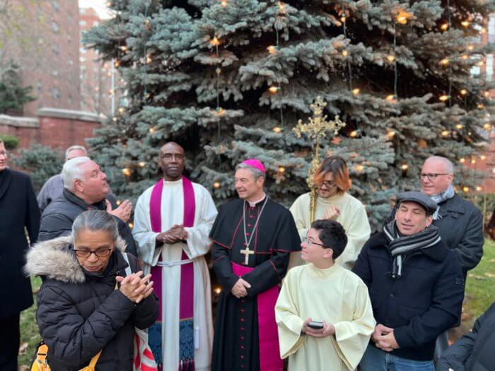 bishop robert brennan with parishioners at christmas tree lighting