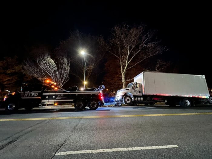 illegally parked tractor-trailer getting booted