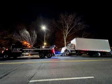 illegally parked tractor-trailer getting booted