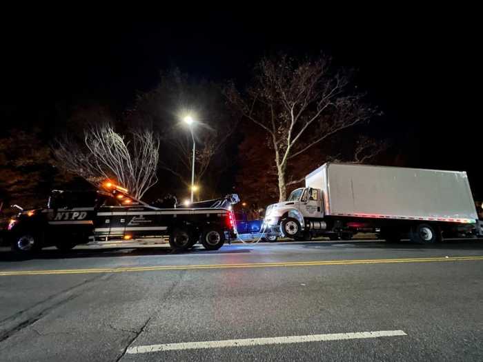 illegally parked tractor-trailer getting booted
