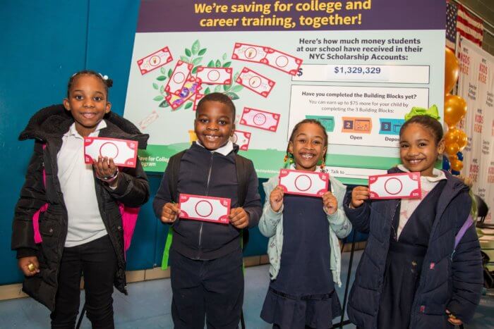 kids pose with scholarship money