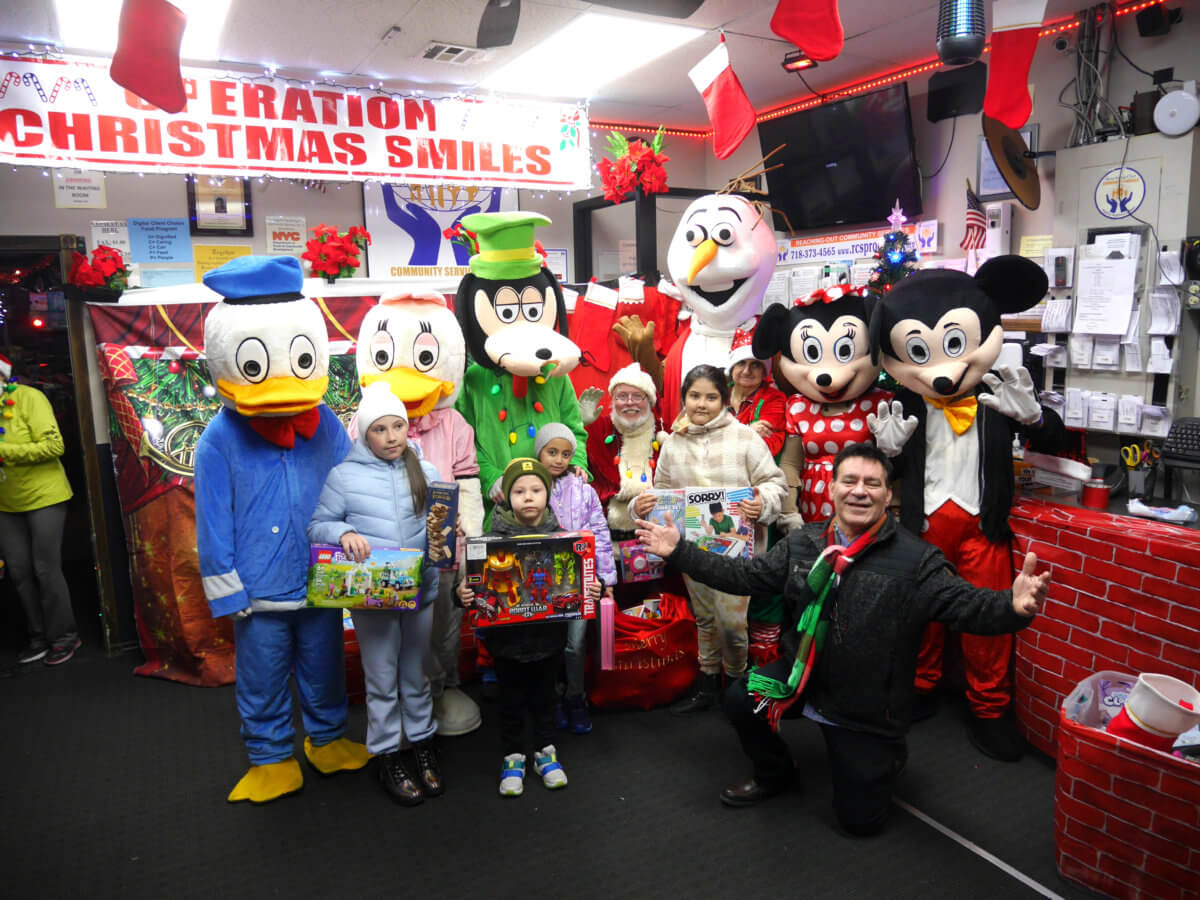 Children receive gifts from Santa at Reaching-out Community Service's 17th annual Operation Christmas Smiles event.