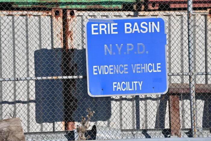 NYPD warehouse evidence sign hanging on fence