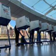 people at voting booths in Brownsville