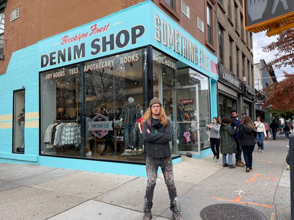 Travis Signs on Something Else Denim shop storefront in Park Slope