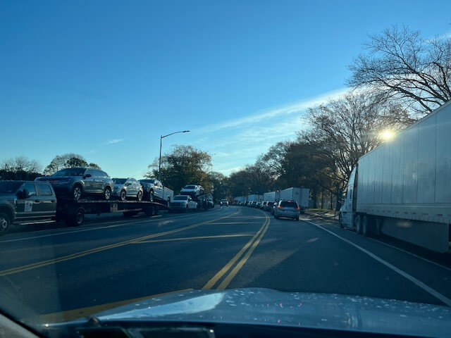 A hosts of tractor-trailers line a Bay Ridge road.