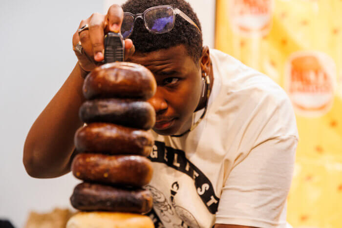 man measuring stack of bagels