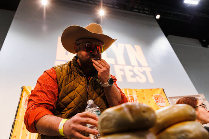 man eating bagels in bagel-eating competition at bagelfest