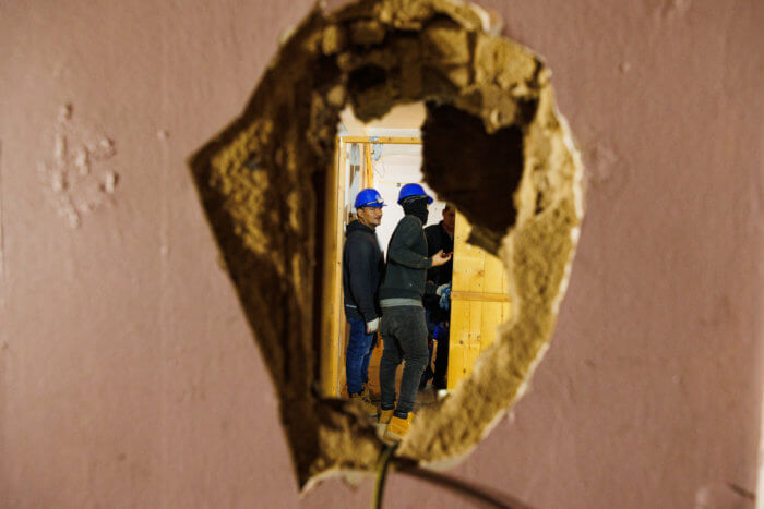 construction workers in PLG apartment after fire