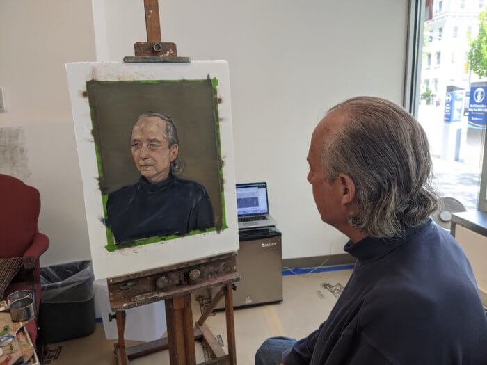 brooklyn man, rick krieger, looking at his free portrait project painting